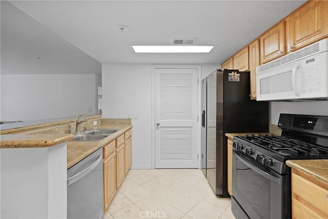 kitchen featuring stainless steel dishwasher, sink, black gas stove, and light brown cabinets