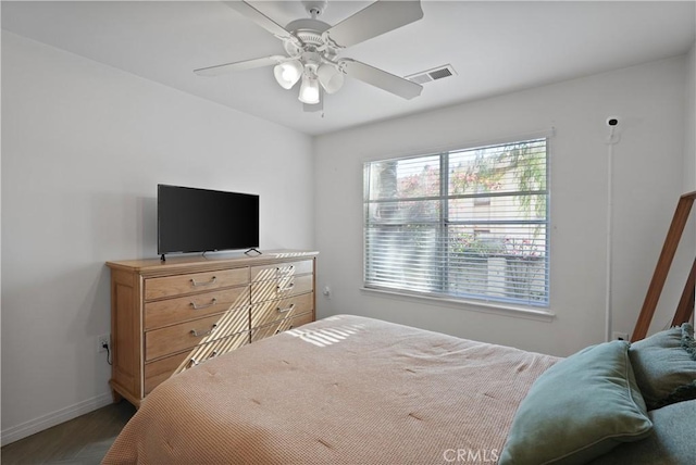 bedroom with ceiling fan and dark hardwood / wood-style floors