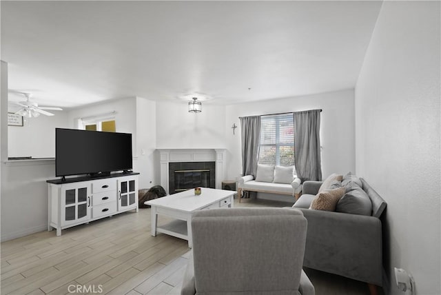 living room with light hardwood / wood-style flooring and ceiling fan