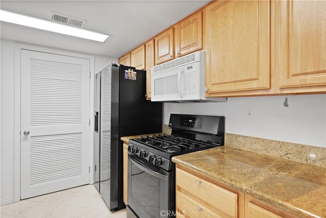 kitchen featuring black gas range and light brown cabinets