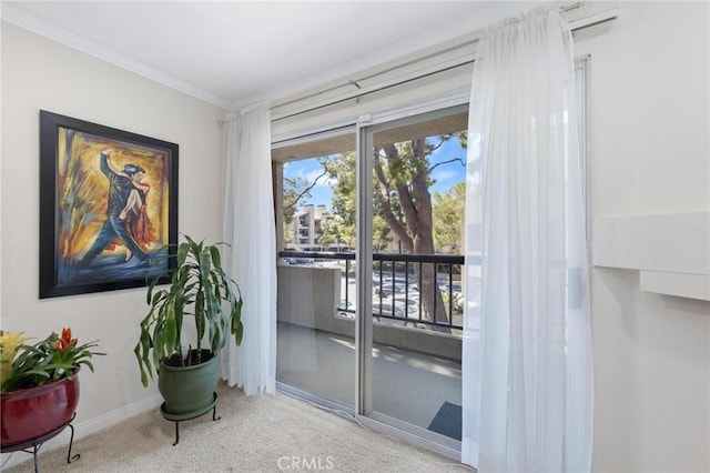 doorway featuring crown molding and light colored carpet