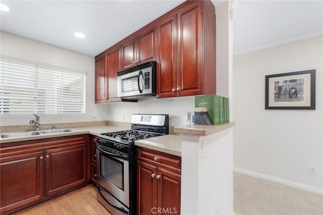 kitchen with appliances with stainless steel finishes, sink, and light stone countertops