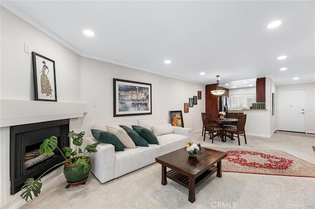 carpeted living room featuring ornamental molding