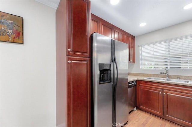 kitchen featuring light wood-type flooring, appliances with stainless steel finishes, and sink