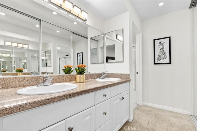 bathroom with vanity and a shower with door