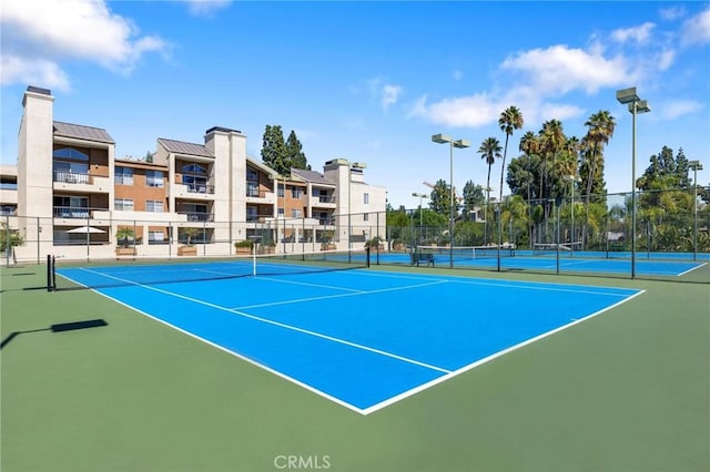 view of tennis court with basketball hoop