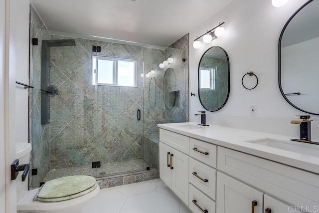 bathroom with vanity, toilet, tile patterned floors, and walk in shower