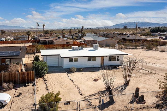 view of front of house with central AC unit and a mountain view