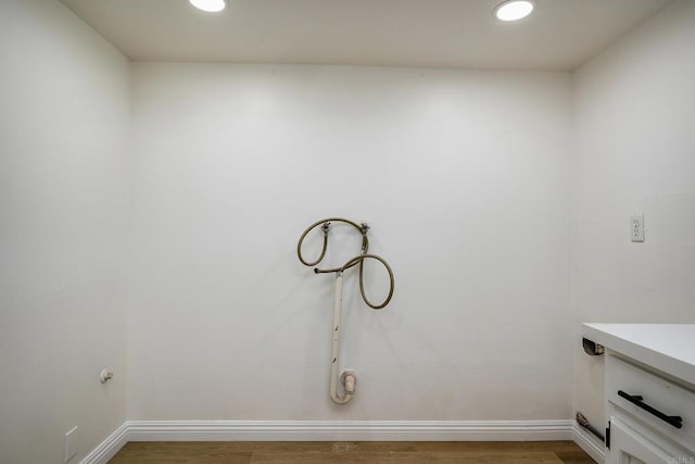 laundry room with hardwood / wood-style flooring