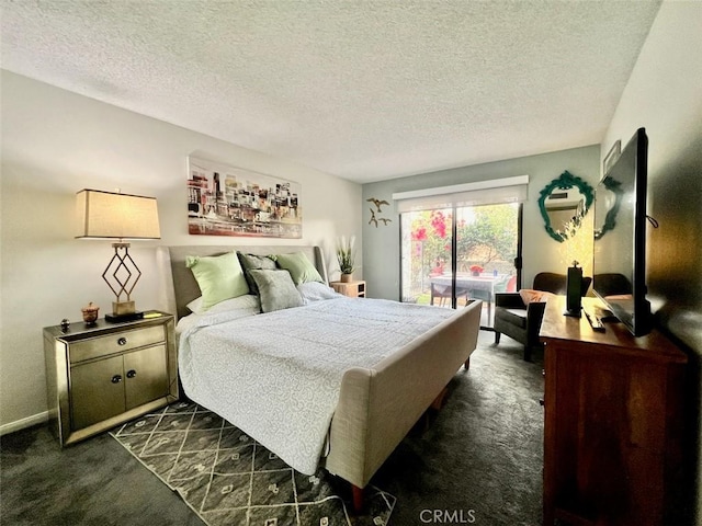 2230 S Palm Canyon Dr Unit 7, Palm Springs, CA 92264 - bedroom featuring dark colored carpet, a textured ceiling, and access to exterior