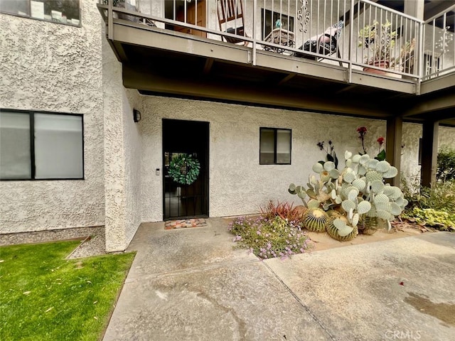 2230 S Palm Canyon Dr Unit 7, Palm Springs, CA 92264 - doorway to property featuring a balcony and stucco siding
