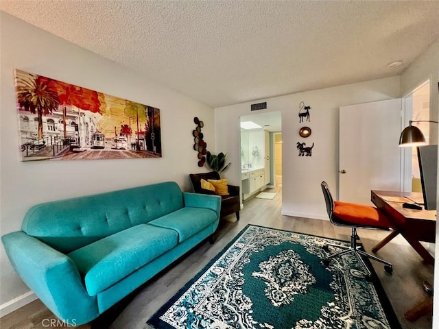 2230 S Palm Canyon Dr Unit 7, Palm Springs, CA 92264 - living area featuring a textured ceiling and wood finished floors