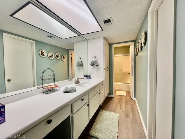 2230 S Palm Canyon Dr Unit 7, Palm Springs, CA 92264 - full bath featuring wood finished floors, vanity, and a textured ceiling