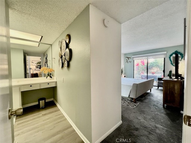 2230 S Palm Canyon Dr Unit 7, Palm Springs, CA 92264 - hallway featuring a textured ceiling and wood finished floors