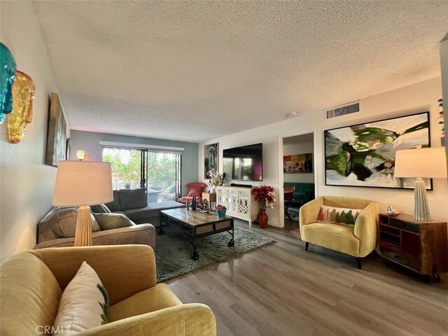 2230 S Palm Canyon Dr Unit 7, Palm Springs, CA 92264 - living room with a textured ceiling and wood finished floors