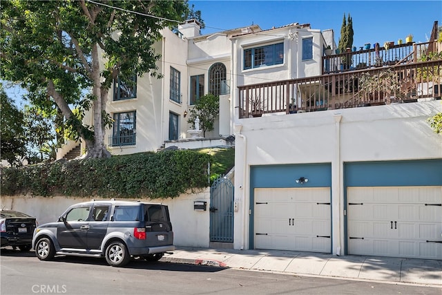 view of front facade with a garage and a balcony