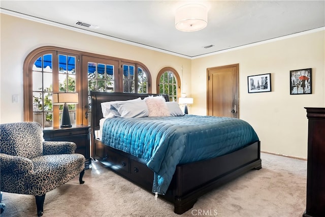 bedroom with ornamental molding and light colored carpet