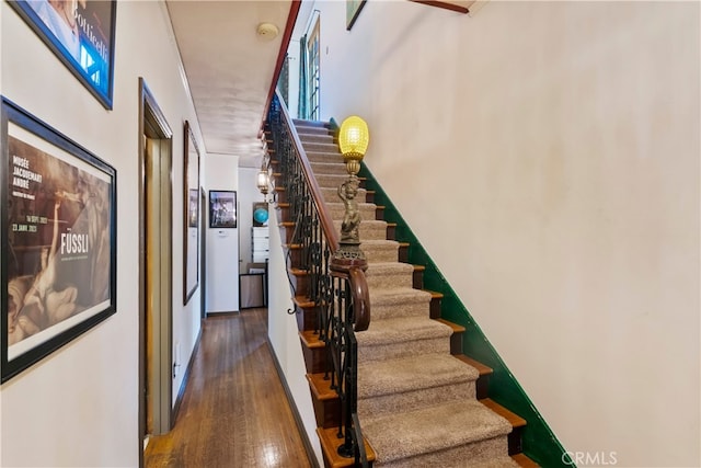 stairs featuring hardwood / wood-style flooring