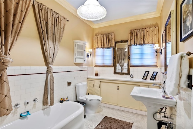 bathroom featuring tile patterned floors, ornamental molding, toilet, tile walls, and a tub