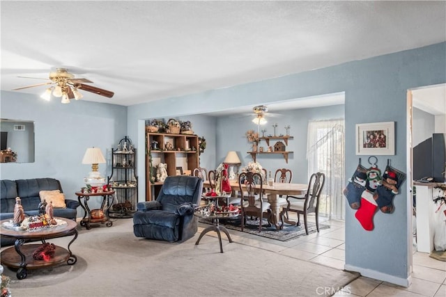 living room featuring ceiling fan and light tile patterned floors