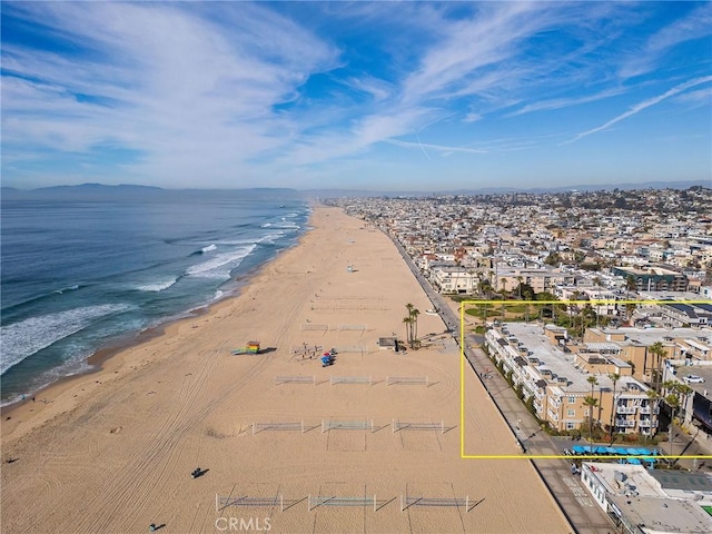 drone / aerial view with a water view and a view of the beach