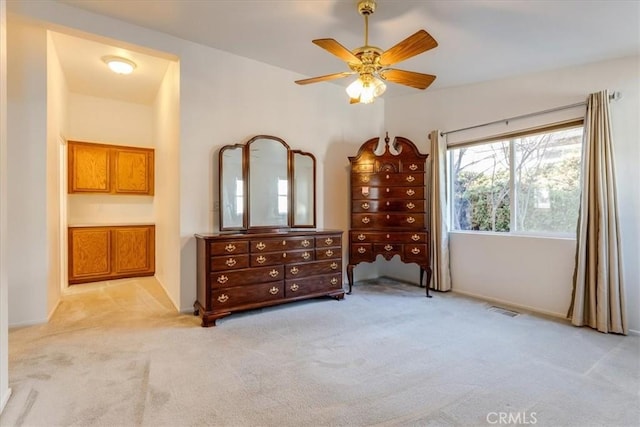 bedroom with light carpet, visible vents, and a ceiling fan