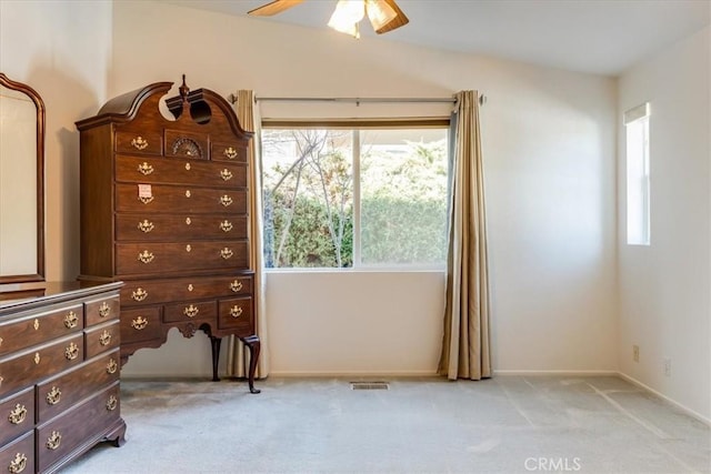 unfurnished bedroom featuring ceiling fan, visible vents, and light colored carpet