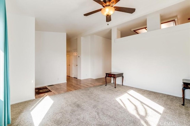 empty room featuring light colored carpet and ceiling fan