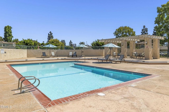 view of pool with a patio and a pergola