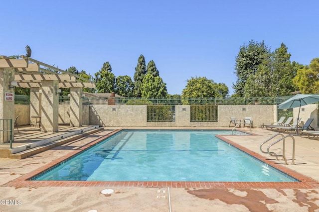 view of pool with a patio and a pergola