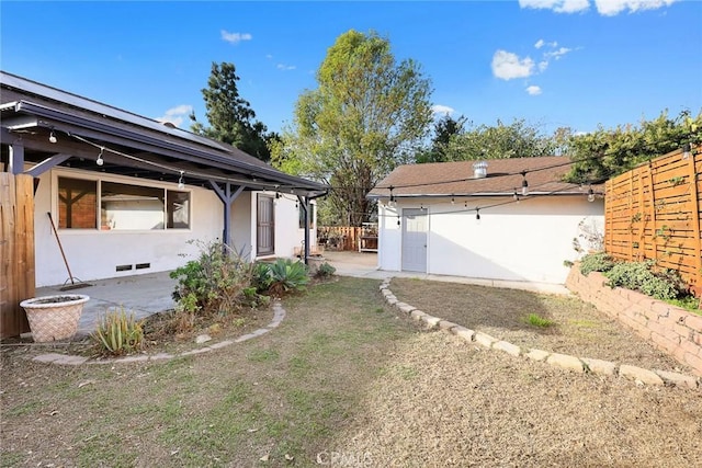 view of yard featuring fence and a patio