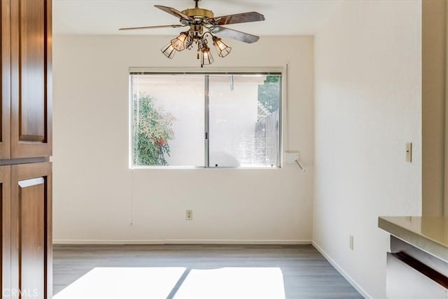 unfurnished dining area featuring ceiling fan and light hardwood / wood-style flooring