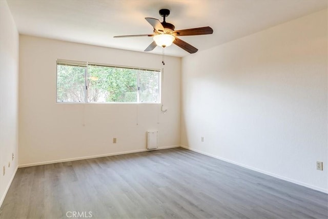 unfurnished room with hardwood / wood-style flooring and ceiling fan