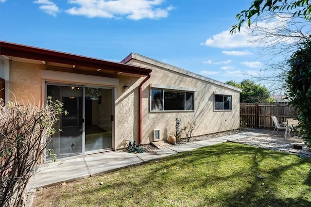 back of house featuring a yard and a patio area