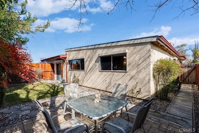 rear view of property with a yard and a patio area