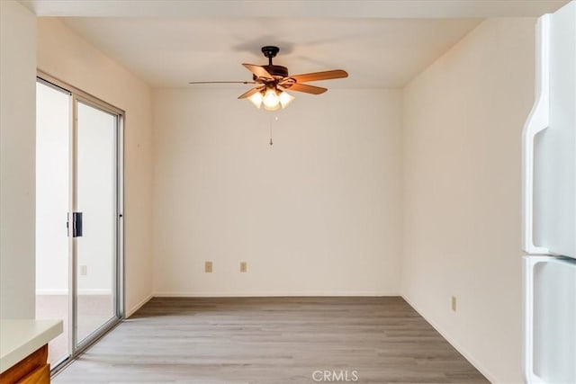 unfurnished room with ceiling fan, plenty of natural light, and light wood-type flooring