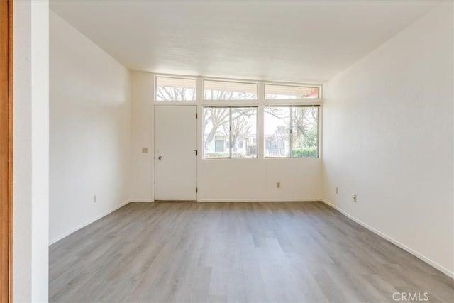 spare room with light wood-type flooring