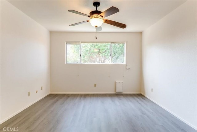 spare room with hardwood / wood-style flooring and ceiling fan