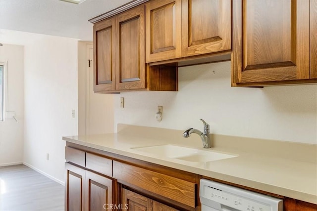 kitchen featuring sink and white dishwasher