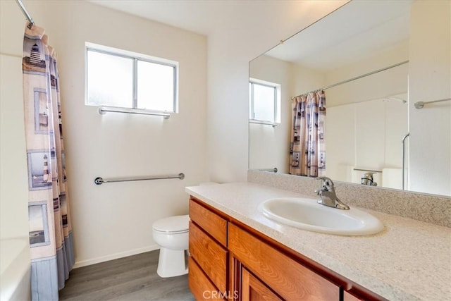 bathroom featuring vanity, toilet, and hardwood / wood-style floors