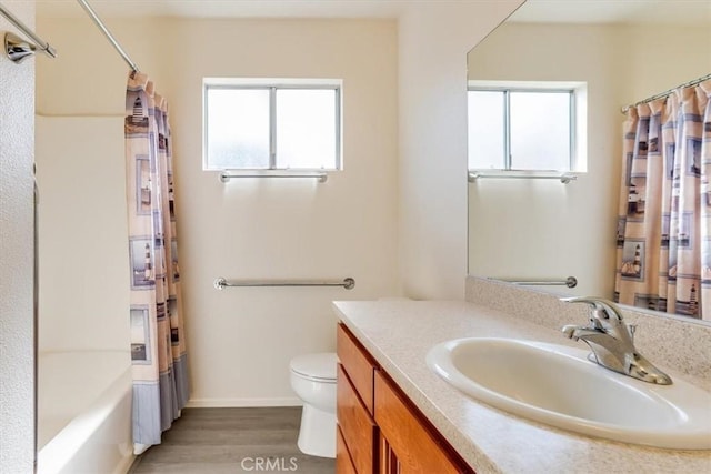 full bathroom featuring toilet, vanity, hardwood / wood-style floors, and shower / bath combo