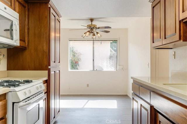 kitchen featuring white appliances and ceiling fan