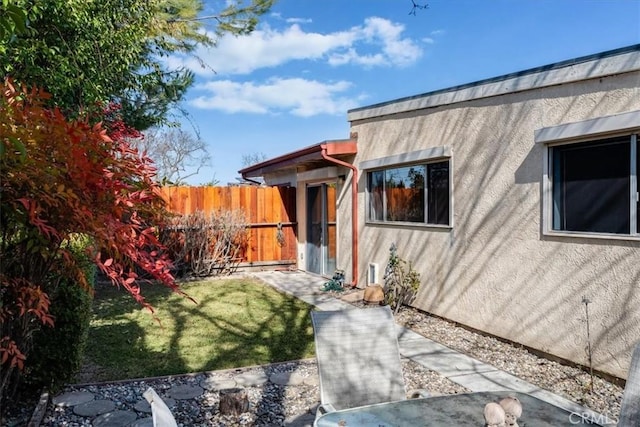 exterior space with a patio area and a lawn