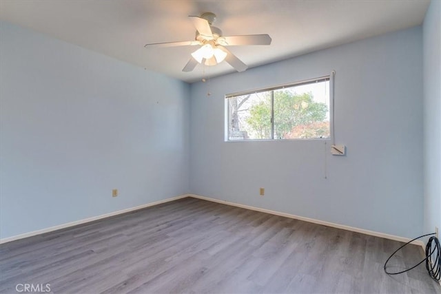 empty room with ceiling fan and light wood-type flooring