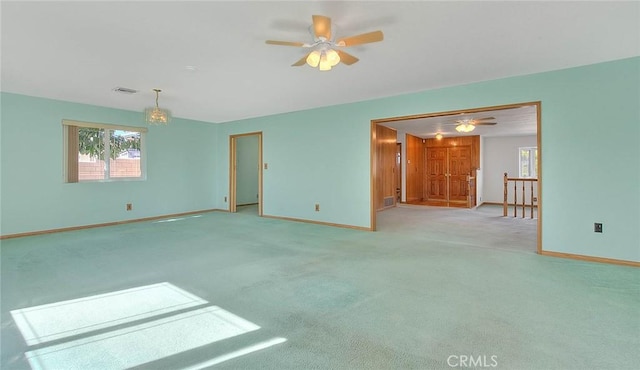 empty room with ceiling fan and light colored carpet