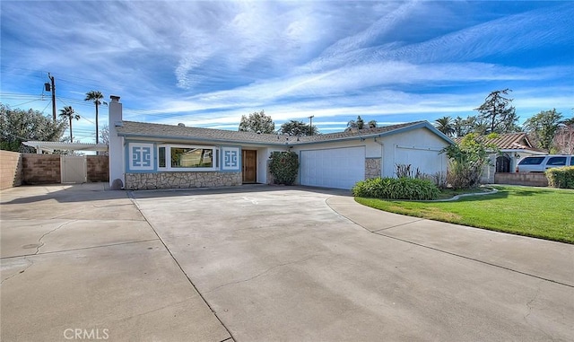 single story home featuring a garage and a front lawn