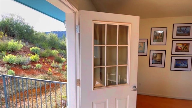 doorway to outside featuring baseboards