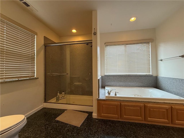 bathroom with a stall shower, recessed lighting, granite finish floor, and a bath