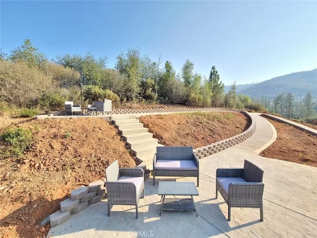 view of patio / terrace featuring an outdoor living space and a mountain view