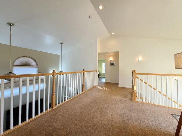 hallway with baseboards, an upstairs landing, carpet floors, high vaulted ceiling, and recessed lighting